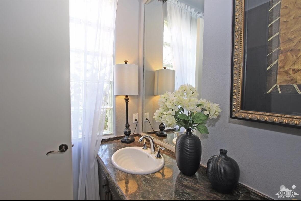104 Loch Lomond Road Rancho Mirage, CA 92270 - Photo 19 of 27 a bathroom with a sink and a mirror