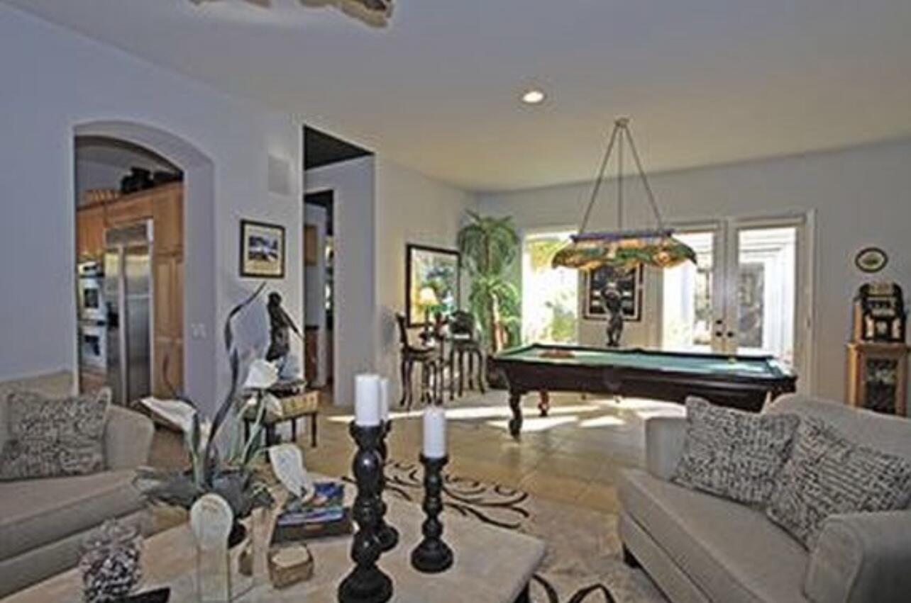 104 Loch Lomond Road Rancho Mirage, CA 92270 - Photo 22 of 27 a living room with furniture and a chandelier