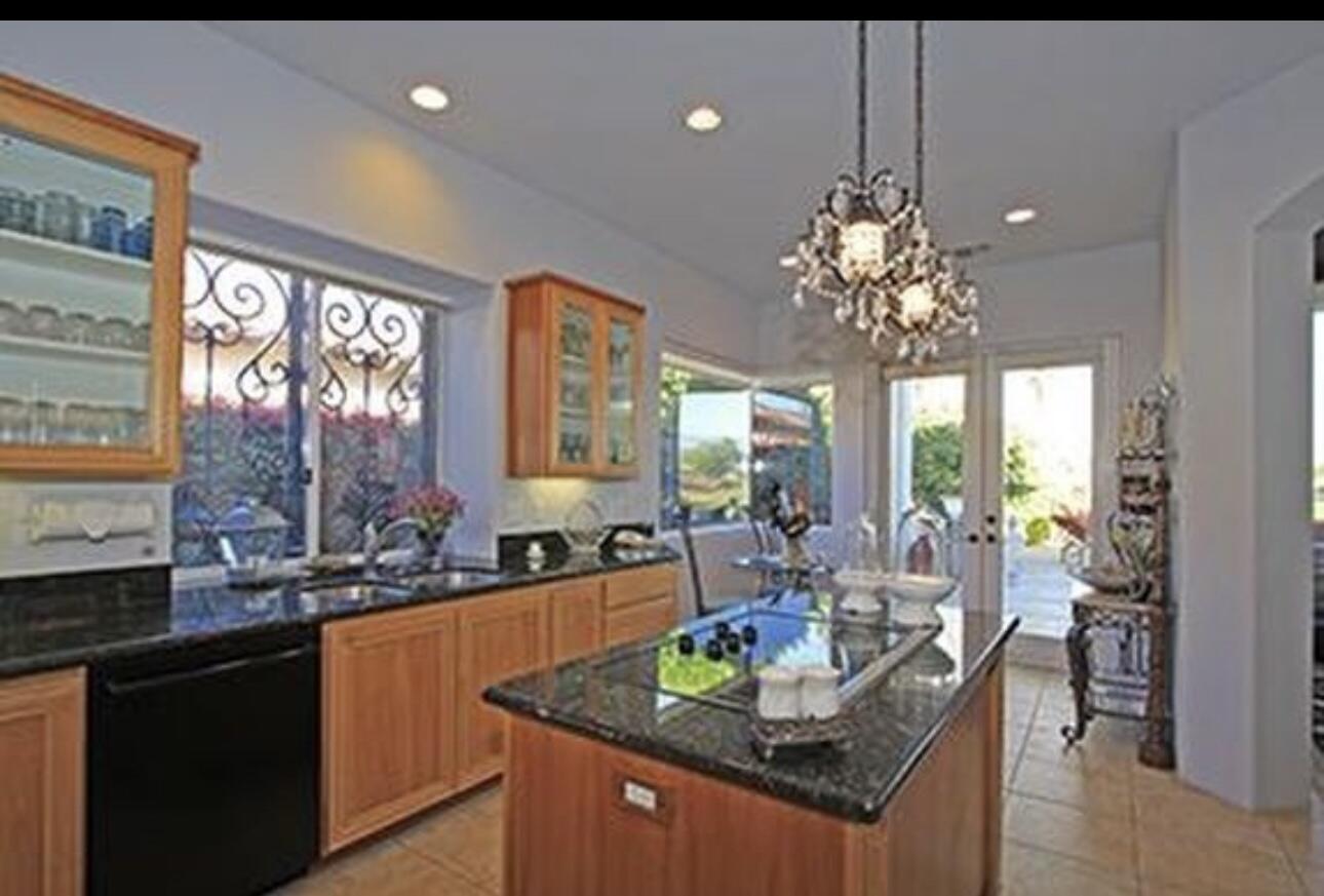 104 Loch Lomond Road Rancho Mirage, CA 92270 - Photo 24 of 27 a view of a dining room kitchen furniture and a chandelier