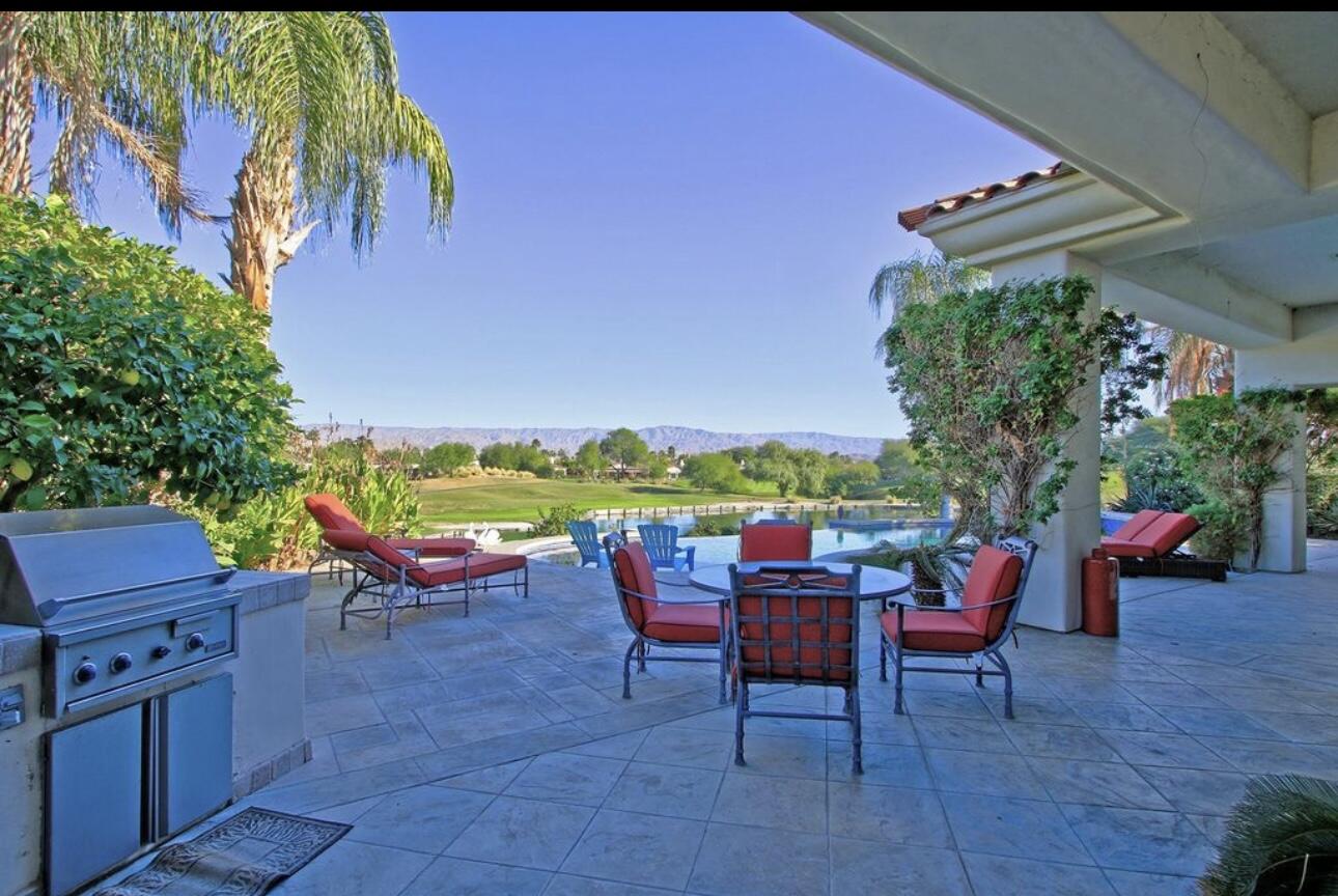104 Loch Lomond Road Rancho Mirage, CA 92270 - Photo 26 of 27 an outdoor sitting area with couch and a potted plant