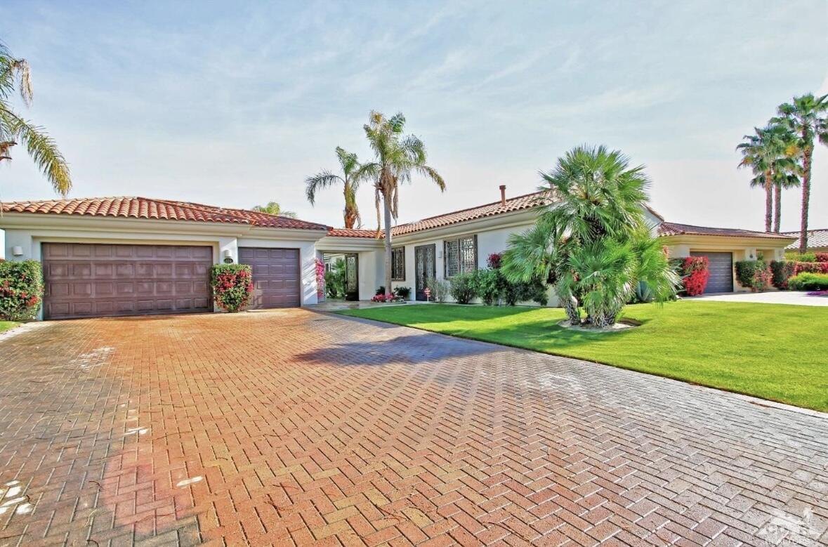 104 Loch Lomond Road Rancho Mirage, CA 92270 - Photo 3 of 27 a front view of a house with a yard and garage