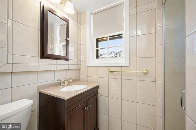 a bathroom with a sink toilet and vanity