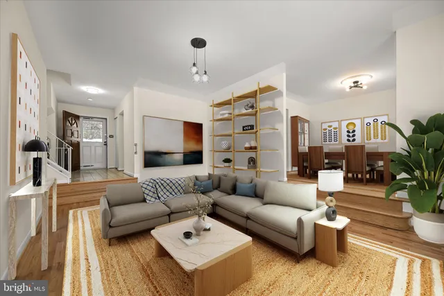 a living room with furniture and view of kitchen