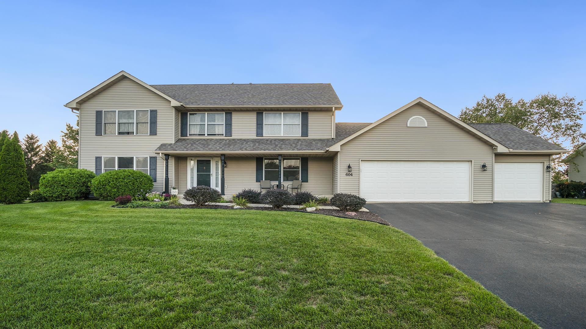 a front view of a house with a yard and garage
