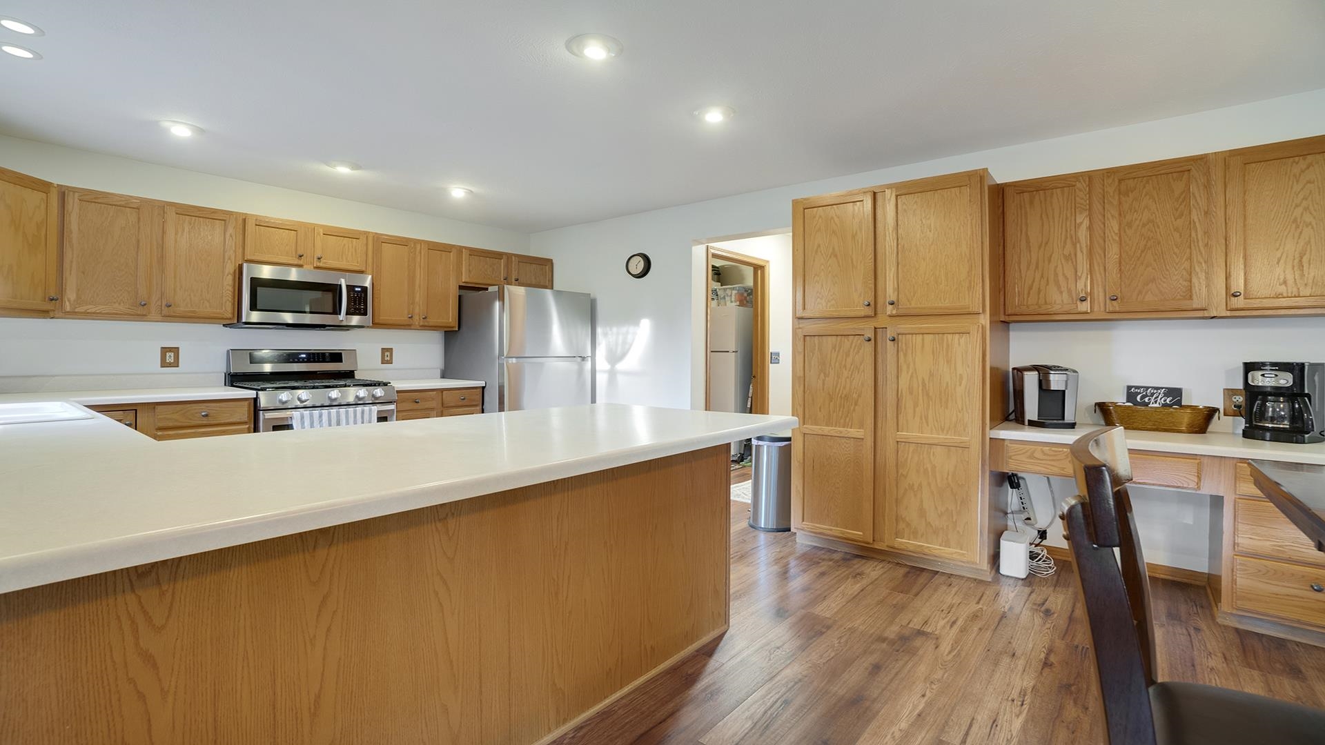 604 Commander Place Belvidere, IL 61008 - Photo 14 of 40 a kitchen with stainless steel appliances a refrigerator a stove a sink dishwasher and a microwave with wooden floor