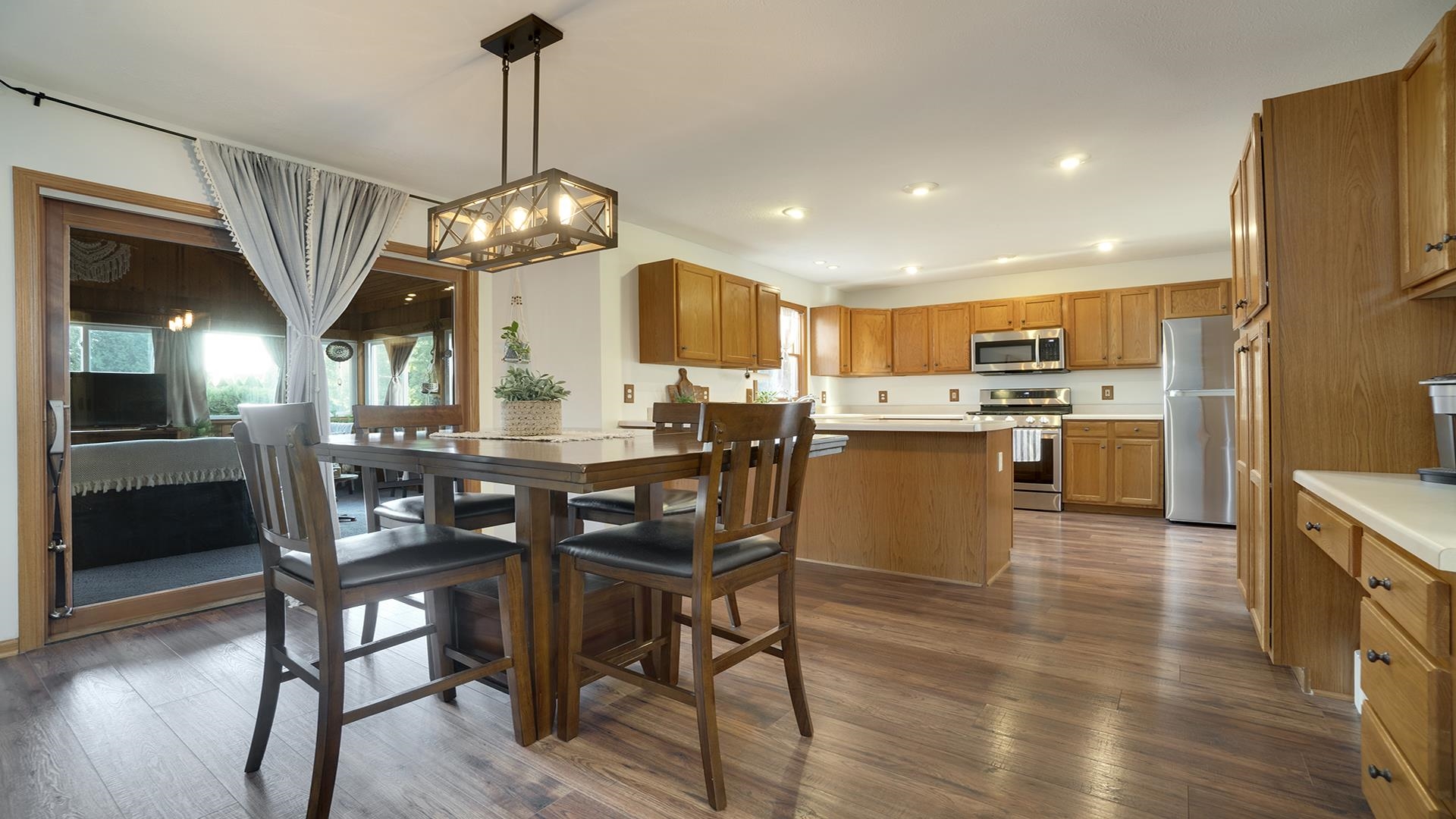 604 Commander Place Belvidere, IL 61008 - Photo 16 of 40 a view of a dining room with furniture a chandelier and wooden floor