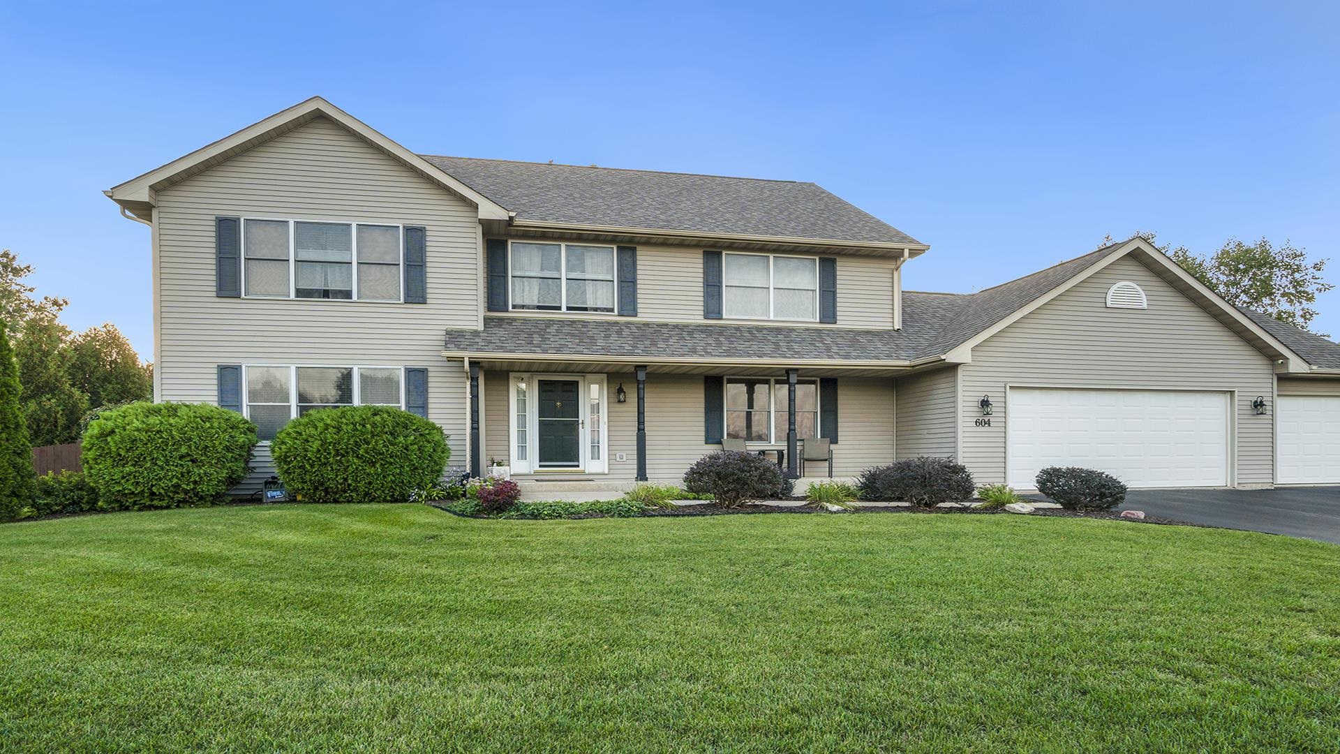 604 Commander Place Belvidere, IL 61008 - Photo 2 of 40 a front view of a house with a yard and garage