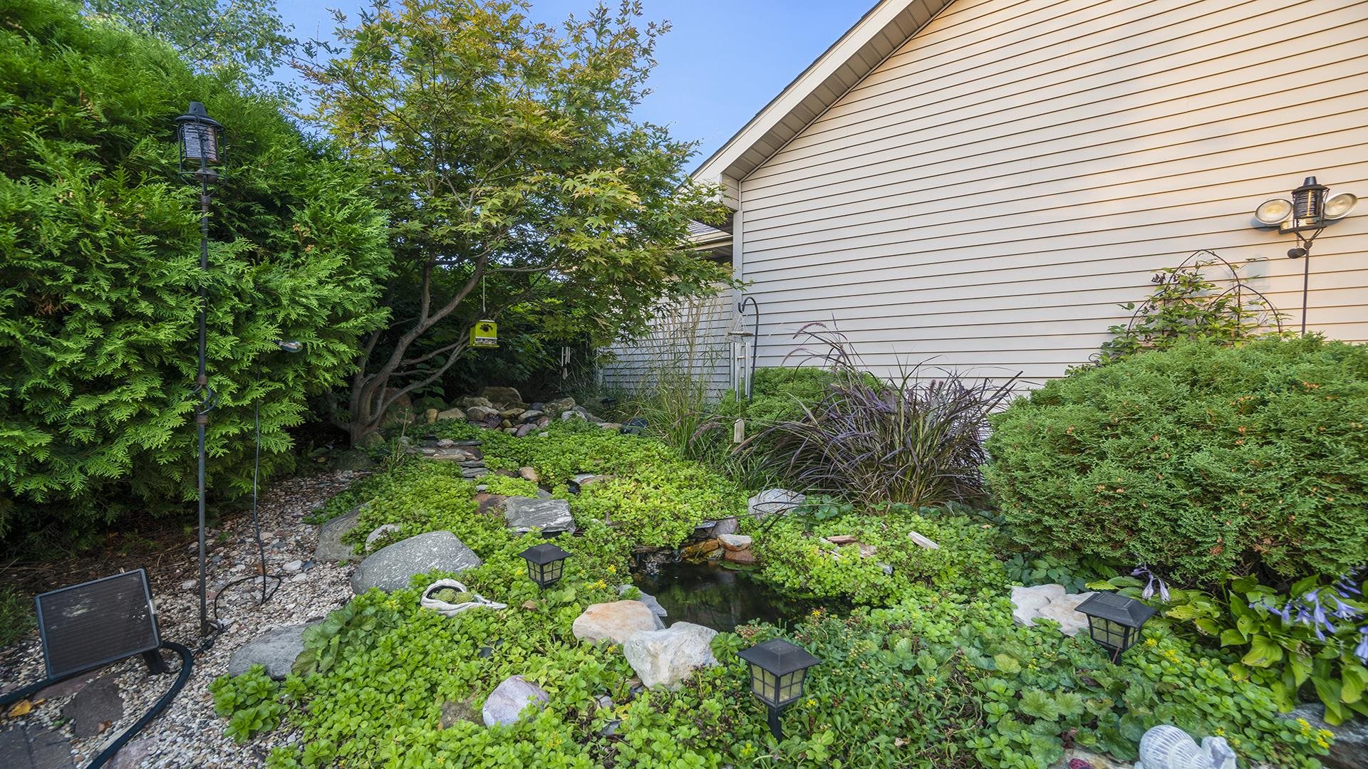604 Commander Place Belvidere, IL 61008 - Photo 36 of 40 a view of a house with a yard and a garden