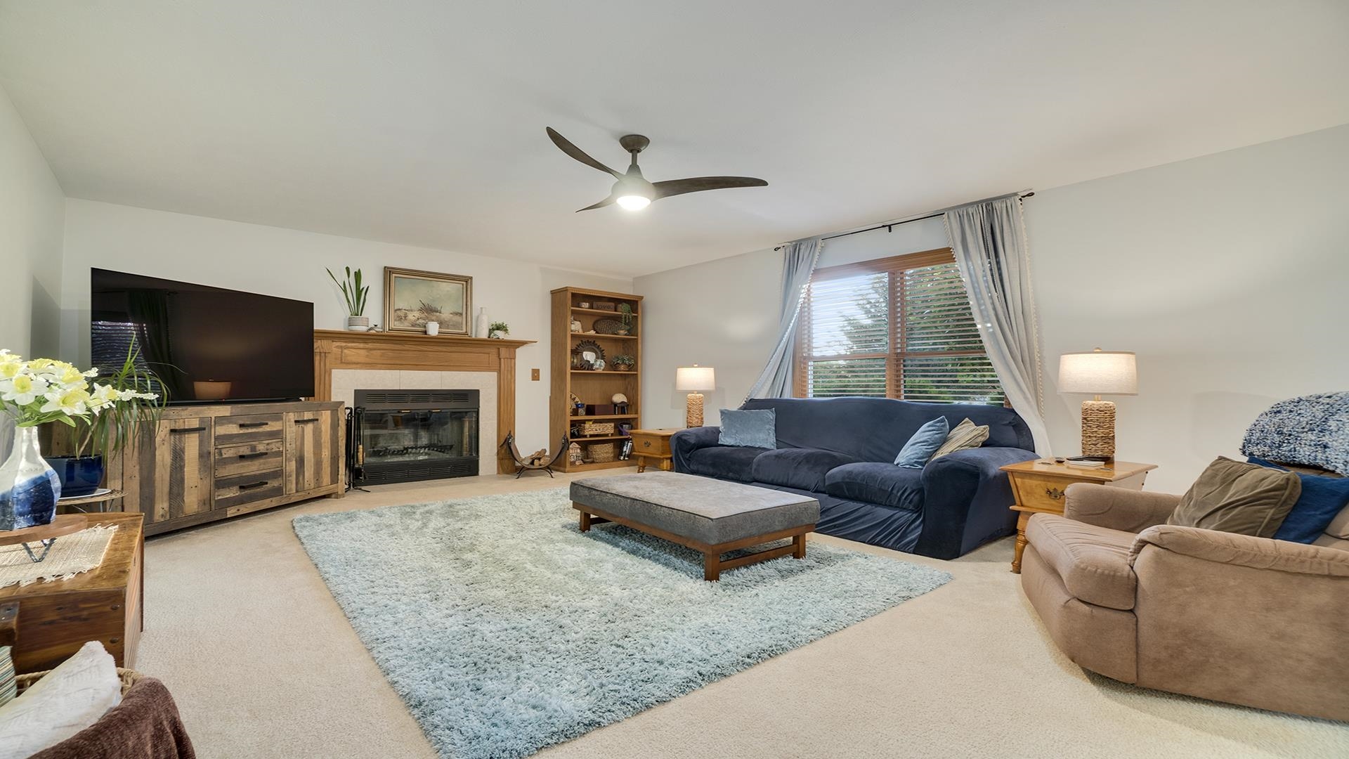 604 Commander Place Belvidere, IL 61008 - Photo 10 of 40 a living room with furniture a fireplace and a flat screen tv