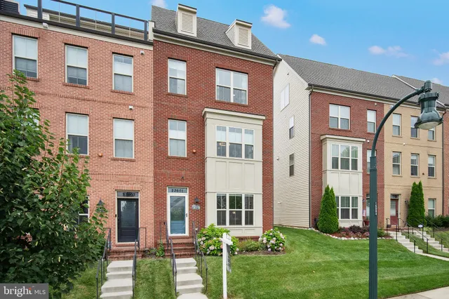 a view of a brick building next to a yard
