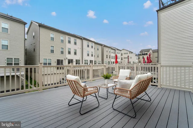 a balcony with furniture and wooden floor
