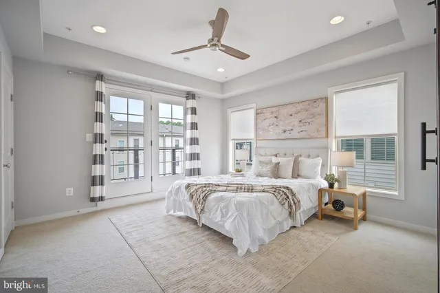 a spacious bedroom with a large bed and a large window