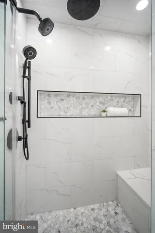 a bathroom with a shower and a sink