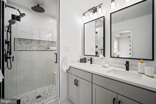 a bathroom with a shower sink and mirror