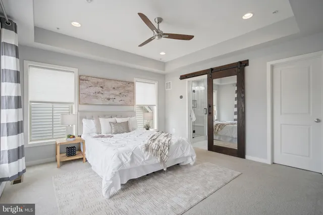 a bedroom with a bed and a large window