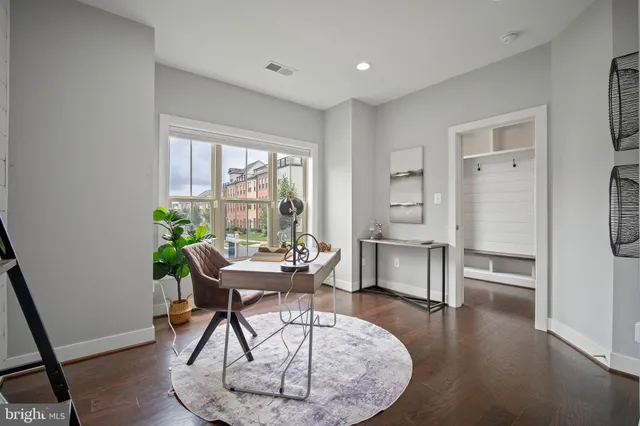 a workspace with furniture window and wooden floor