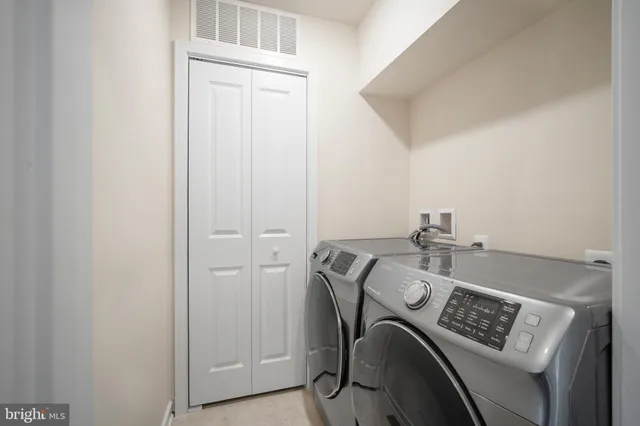 a view of storage and utility room with washer and dryer