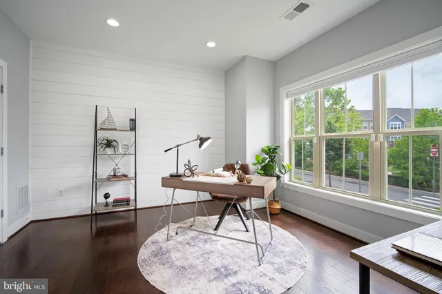 a workspace with furniture hardwood and a window