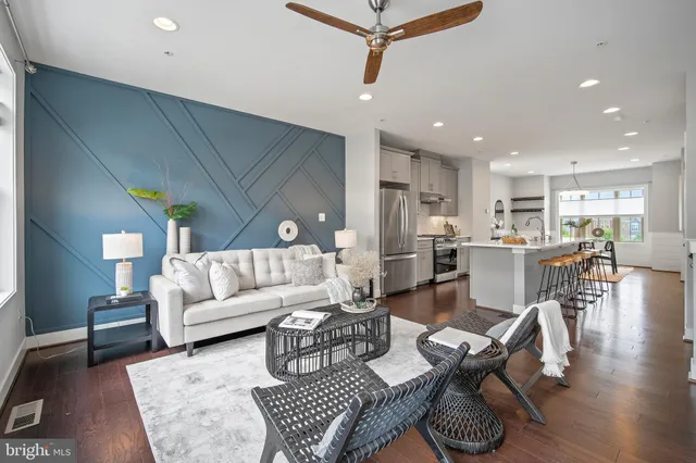 a living room with furniture and wooden floor
