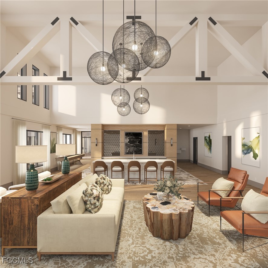 5001 Palm Point, Unit A449 Fort Myers, FL 33907 - Photo 5 of 9 a living room with furniture a chandelier and kitchen view