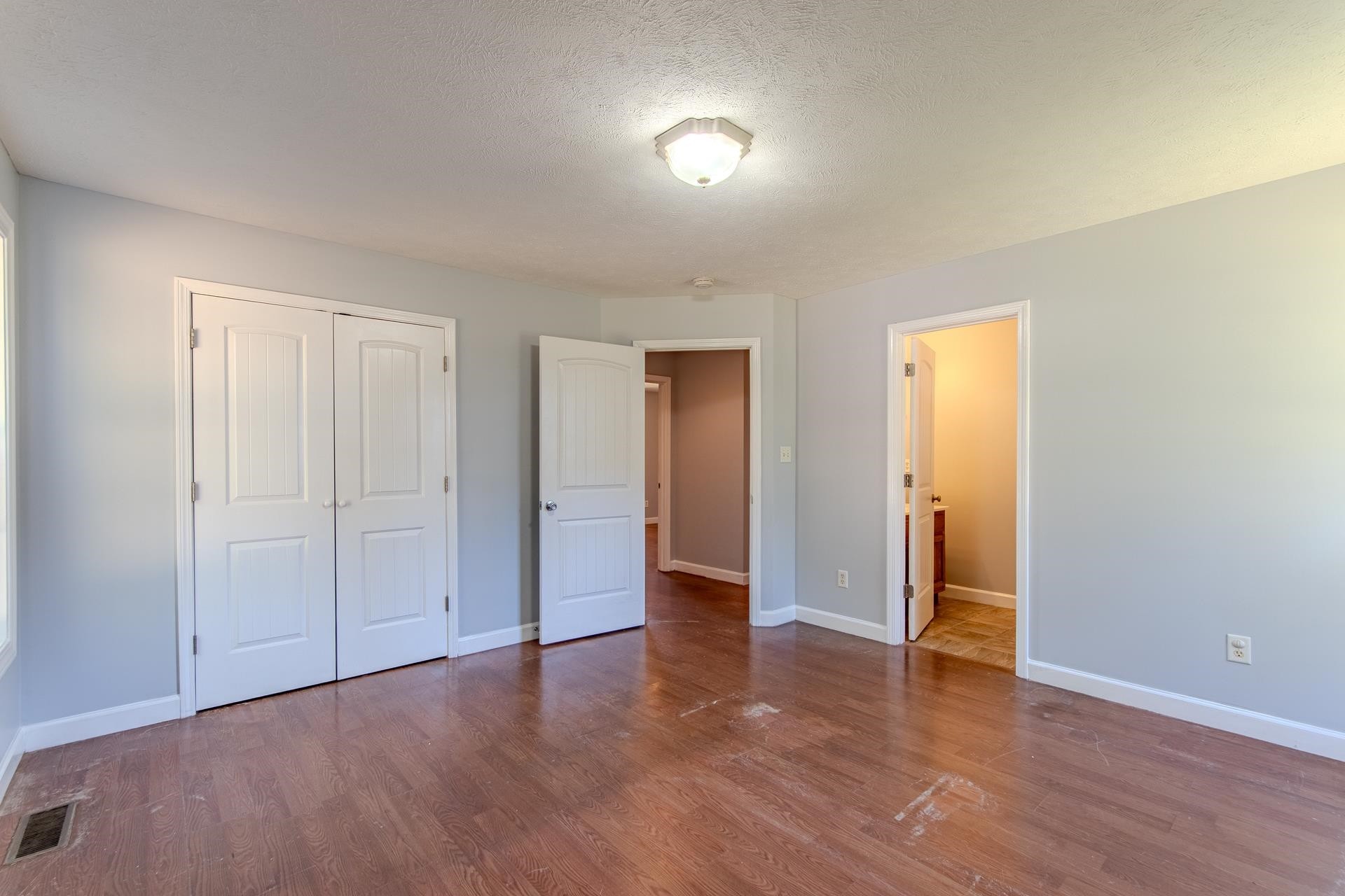 150 Hollis Way Adamsville, TN 38310 - Photo 20 of 37 an empty room with wooden floor and windows