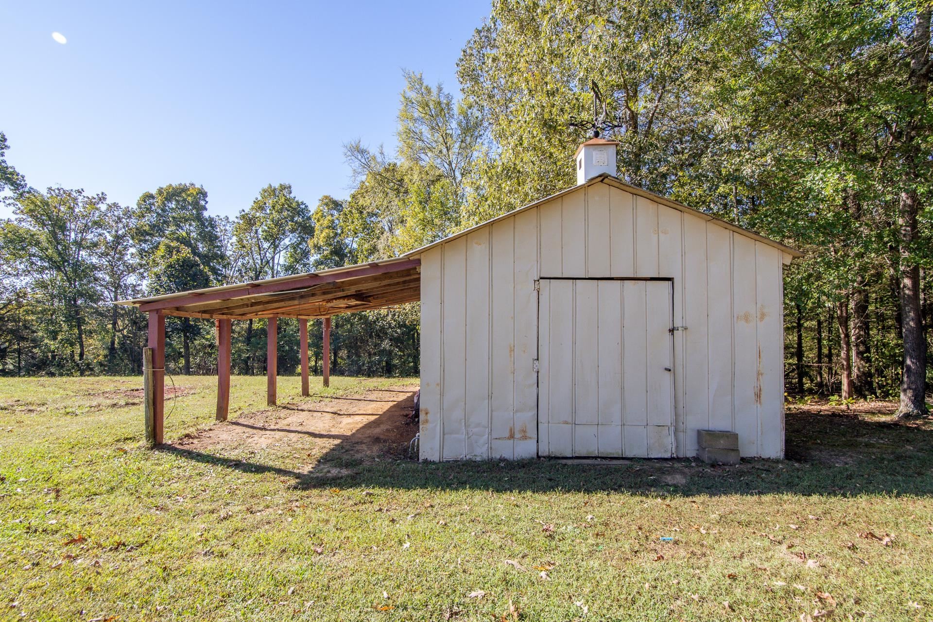 150 Hollis Way Adamsville, TN 38310 - Photo 34 of 37 a backyard of a house with a small yard and wooden fence