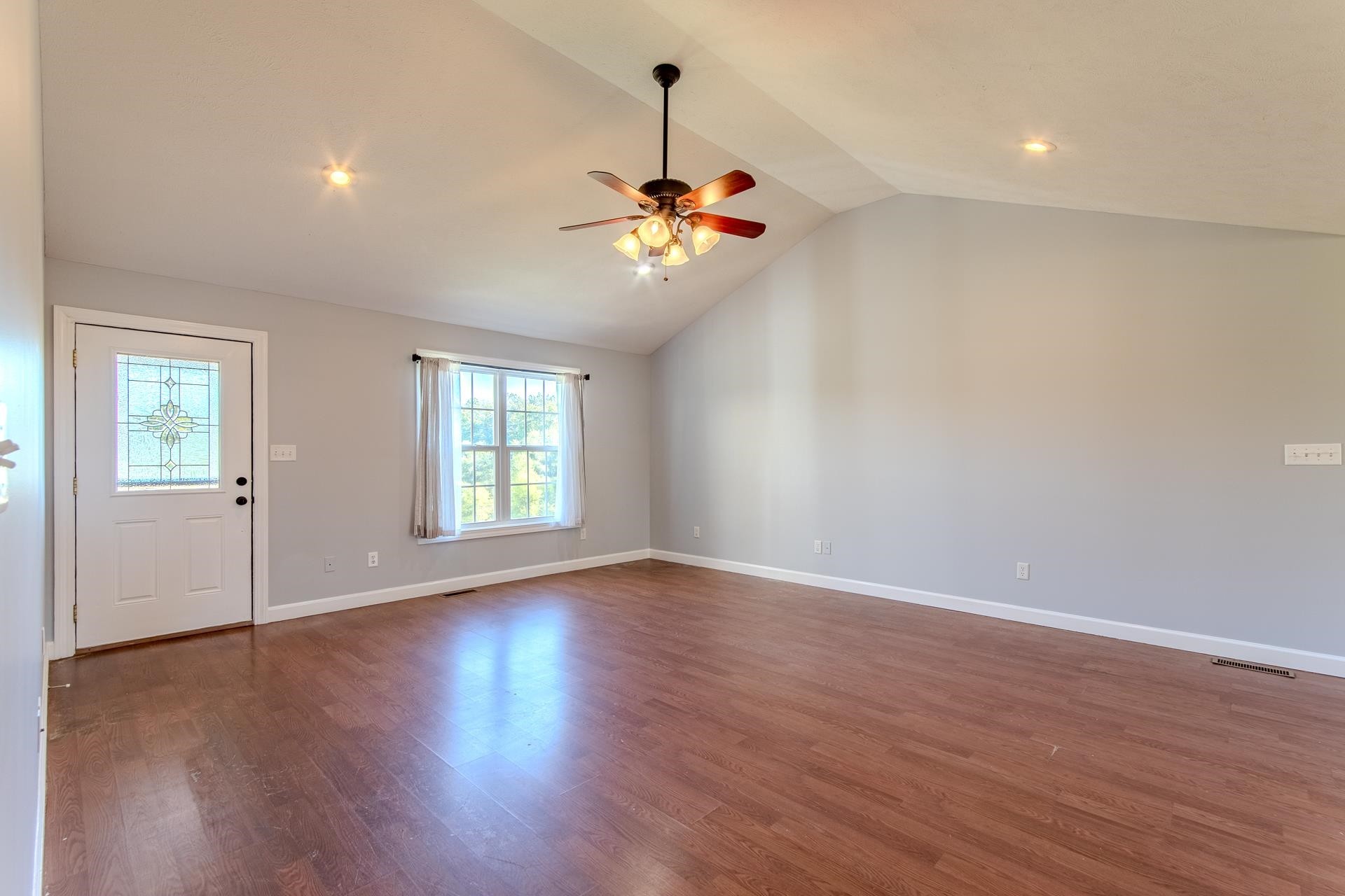 150 Hollis Way Adamsville, TN 38310 - Photo 10 of 37 a view of an empty room with window and wooden floor