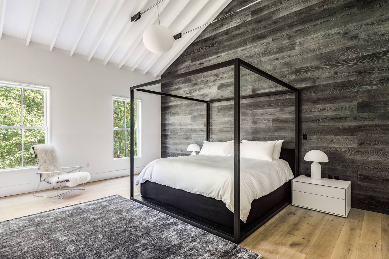 42 Old Noyack Path Sag Harbor, NY 11963 - Photo 17 of 43 a bedroom with a bed and a large window