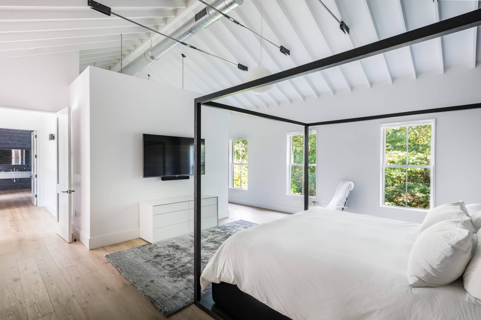 42 Old Noyack Path Sag Harbor, NY 11963 - Photo 18 of 43 a bedroom with a bed and a flat screen tv