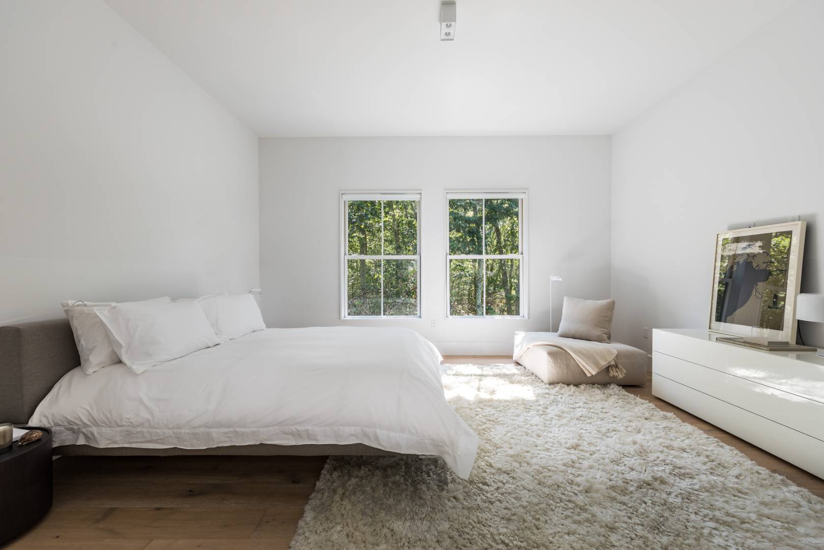 42 Old Noyack Path Sag Harbor, NY 11963 - Photo 28 of 43 a bedroom with a bed and a couch