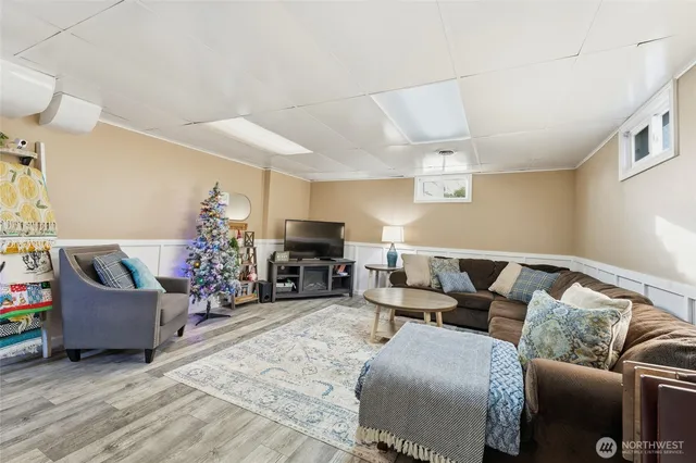 a bedroom with a bed and large windows