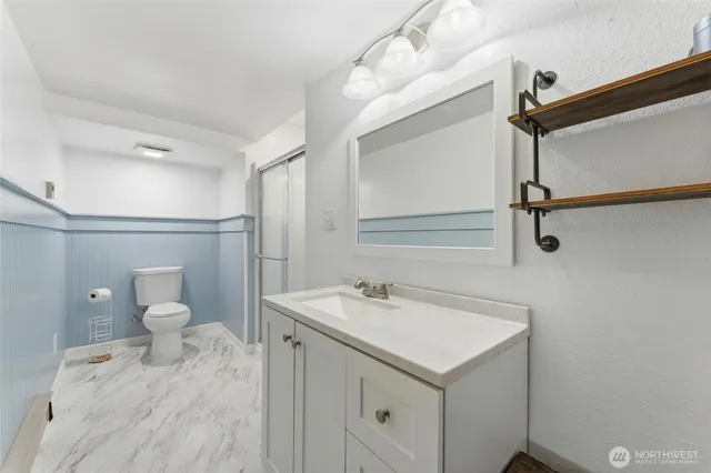 a bathroom with a glass shower door