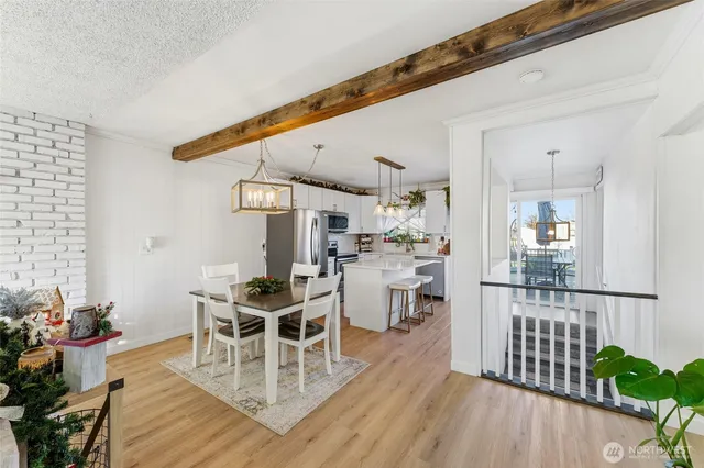 a dining room with furniture wooden floor and a chandelier