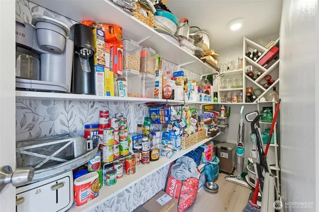 a view of a hallway with wooden floor and entryway