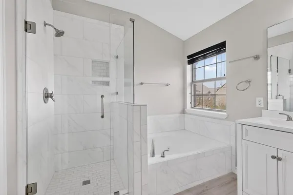 a bath room with a bath tub and a shower