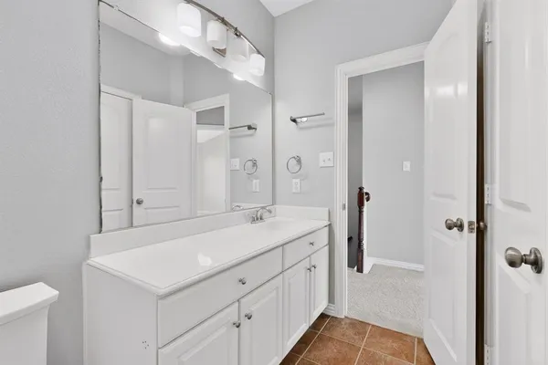 a spacious bathroom with a sink and a mirror