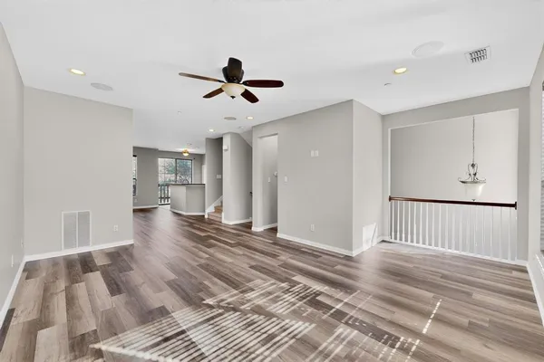 a view of a room with wooden floor and windows