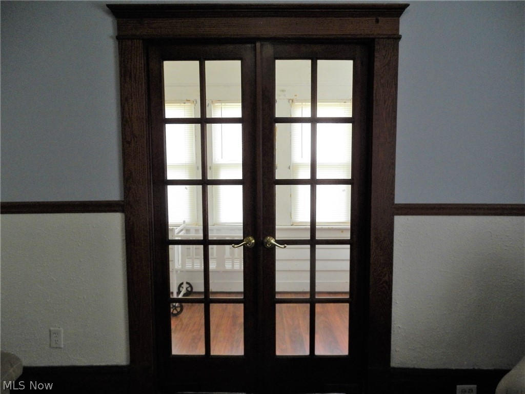 355 South 9th Street Coshocton, OH 43812 - Photo 11 of 35 doors in living room leading out into the sunroom