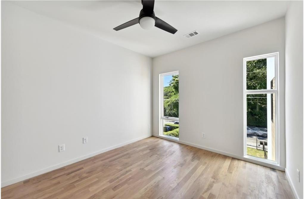 536 Highland Avenue Northeast, Unit B Atlanta, GA 30312 - Photo 29 of 62 a view of an empty room with window and wooden floor