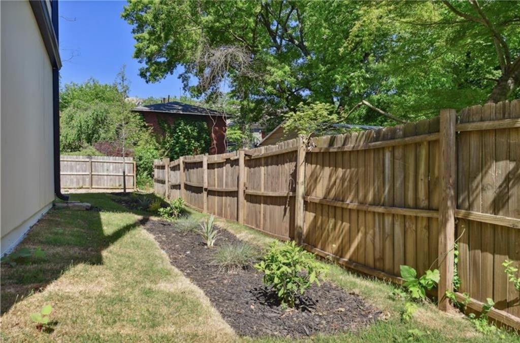 536 Highland Avenue Northeast, Unit B Atlanta, GA 30312 - Photo 41 of 62 a view of a backyard with a small cabin and a chair