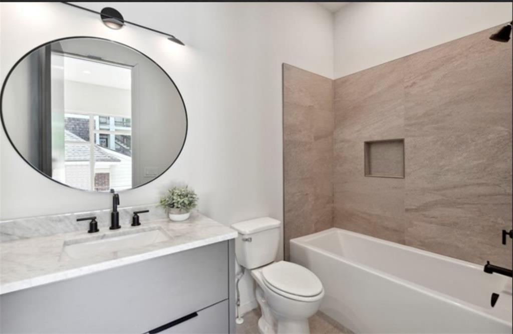 536 Highland Avenue Northeast, Unit B Atlanta, GA 30312 - Photo 8 of 62 a bathroom with a sink a toilet and a mirror