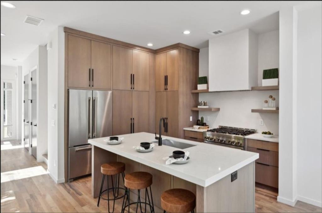 536 Highland Avenue Northeast, Unit B Atlanta, GA 30312 - Photo 9 of 62 a kitchen with a sink a stove a refrigerator and chairs