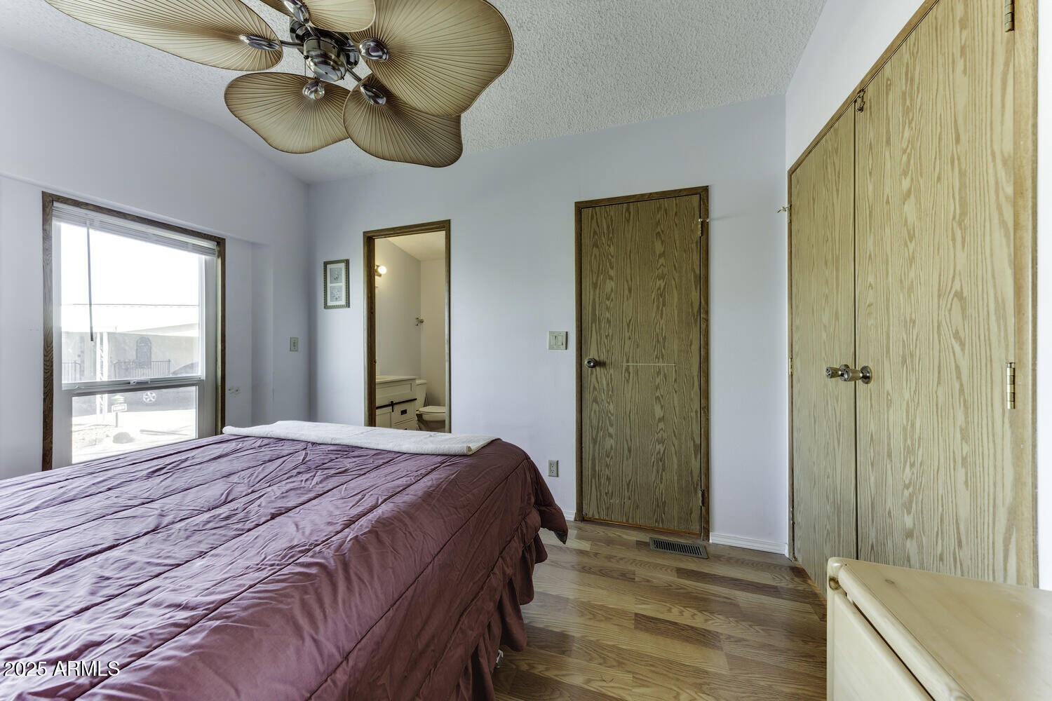 17200 West Bell Road, Unit 1745 Surprise, AZ 85374 - Photo 17 of 24 a bedroom with a bed and a chandelier