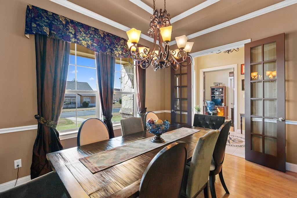 117 Citation Drive Cresson, TX 76035 - Photo 12 of 40 Dining space with crown molding, a chandelier, french doors, wood finished floors, and a raised ceiling