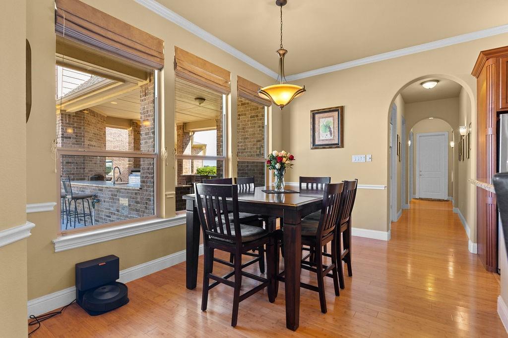 117 Citation Drive Cresson, TX 76035 - Photo 18 of 40 Dining area featuring arched walkways, light wood-style floors, and crown molding