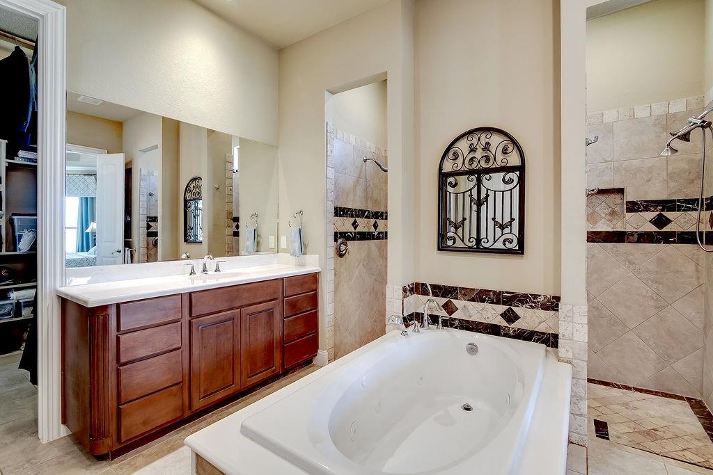 117 Citation Drive Cresson, TX 76035 - Photo 23 of 40 Full bathroom featuring a tub with jets, vanity, light tile patterned floors, and a walk in shower