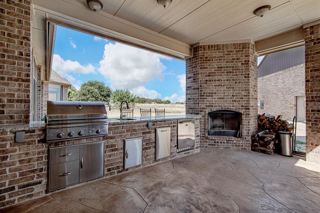 117 Citation Drive Cresson, TX 76035 - Photo 32 of 40 View of patio / terrace with exterior kitchen and an outdoor brick fireplace