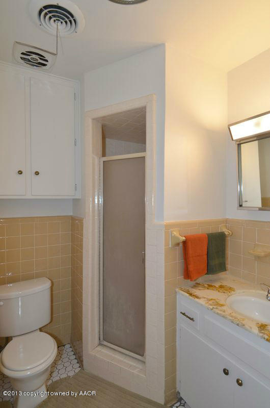 5111 Shield Drive Amarillo, TX 79110 - Photo 12 of 23 a bathroom with a toilet sink and mirror
