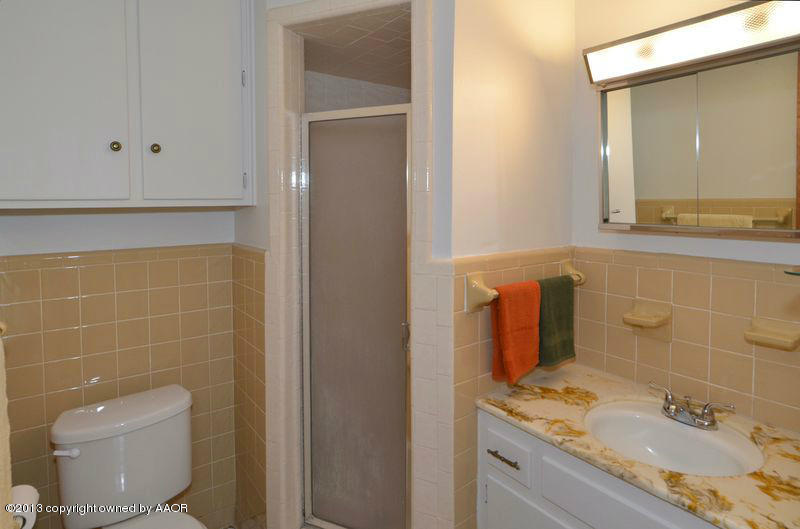 5111 Shield Drive Amarillo, TX 79110 - Photo 13 of 23 a bathroom with a granite countertop sink toilet and mirror