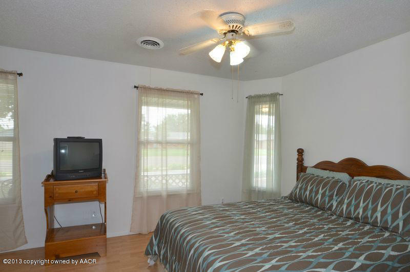 5111 Shield Drive Amarillo, TX 79110 - Photo 14 of 23 a bedroom with a bed and a tv